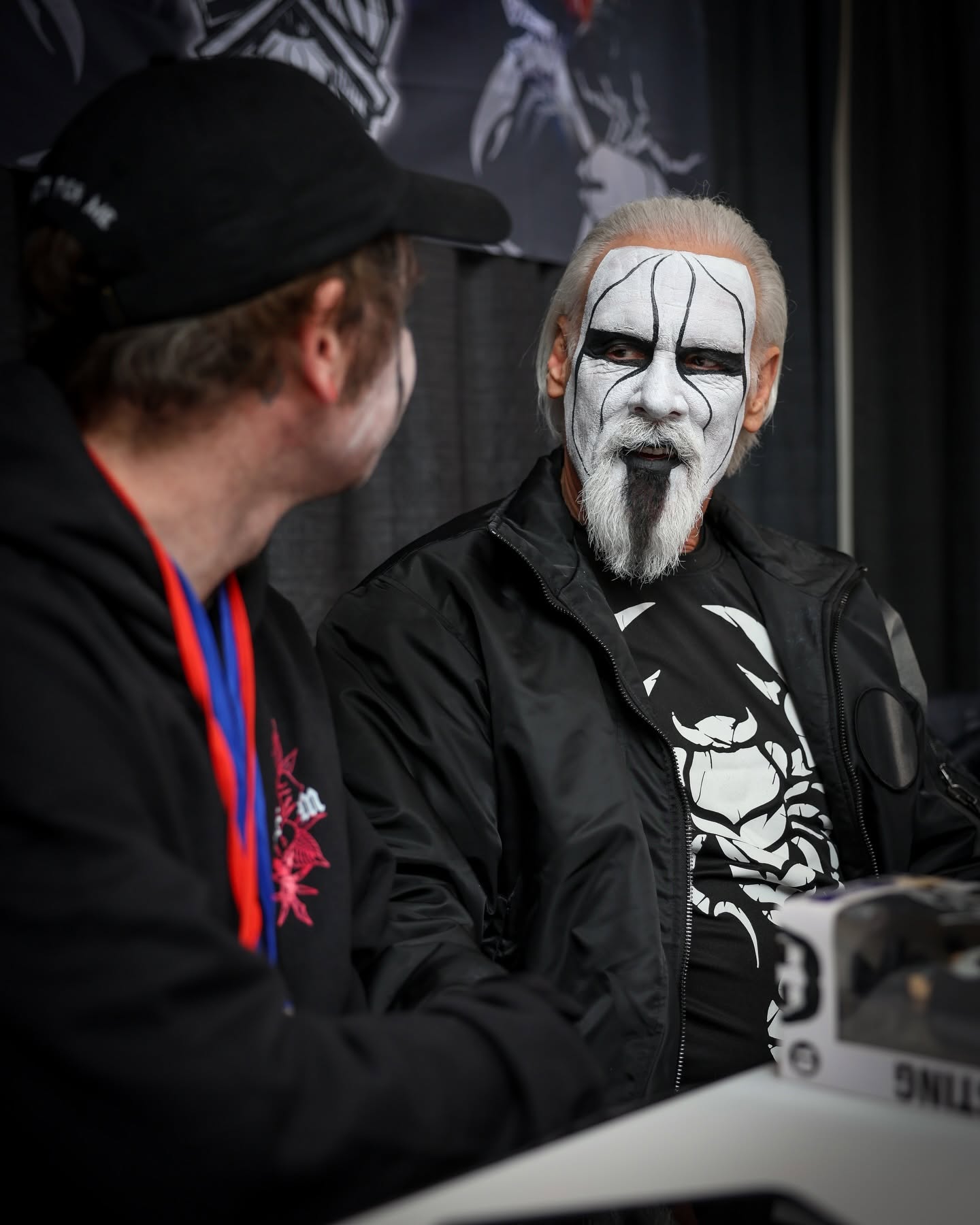 Sting connecting with a fan at a meet-and-greet appearance